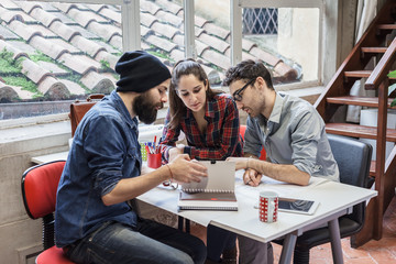 Teamwork. Three young architects working on a project