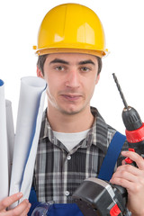 a young worker with a drill and plans