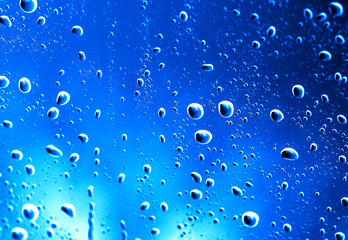fresh background of water drops on blue surface