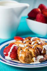 close view on fresh baked croissant with cream and fruits