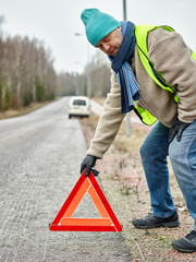 Male and warning triangle