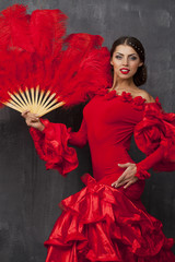 Woman traditional Spanish Flamenco dancer dancing in a red dress