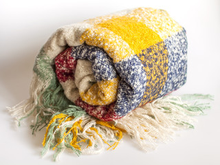 Warm fluffy plaid in a cage of various colors with a fringe