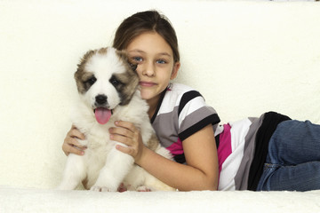 child hugging a puppy