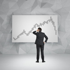 businessman looking to chart