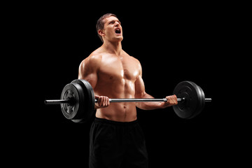 Fototapeta na wymiar Muscular bodybuilder lifting with weights