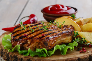Grilled steak on the bone with potatoes