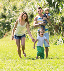 Fototapeta premium Family of four in sunny park