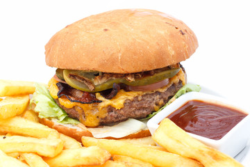Cheese burger and chips with ketchup on a white plate.