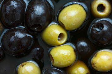 Mixed black and green olives in brine.