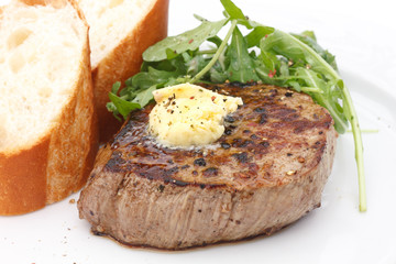 Roast pork tenderloin fillet steak topped with melting butter.