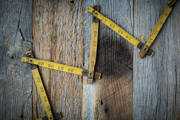 Old Tape Measure on Rustic Wood Background