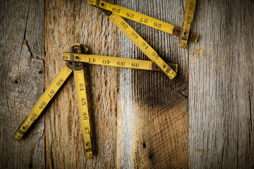 Old Tape Measure on Rustic Wood Background