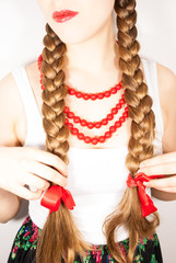 A young beautiful girl wearing folk costume with long tresses