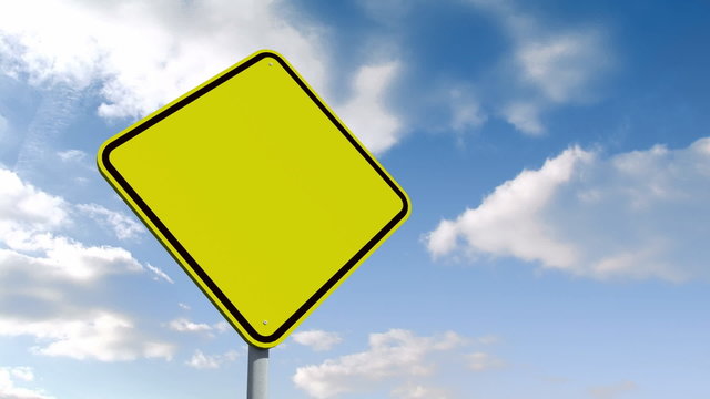 Empty yellow road sign over cloudy sky