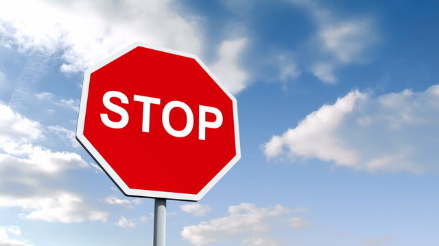 STOP road sign over cloudy sky
