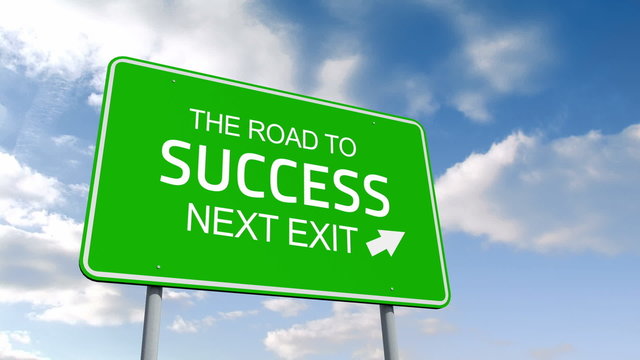 The road to success and next exit road sign over cloudy sky
