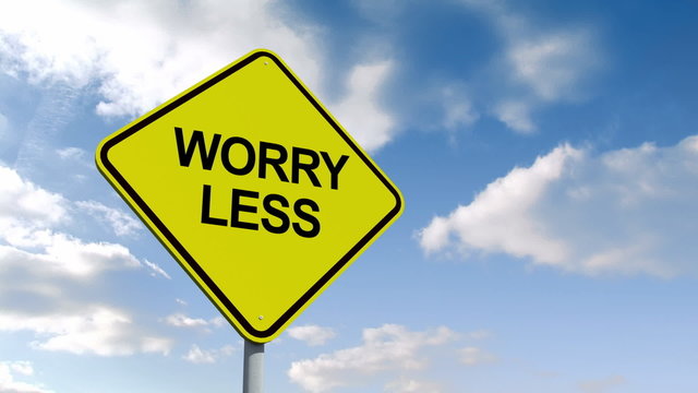 Worry less sign against blue sky
