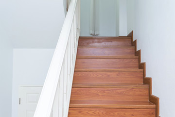 wooden staircase made from laminate wood in white modern house