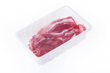 raw pork in plastic box package isolated on white background