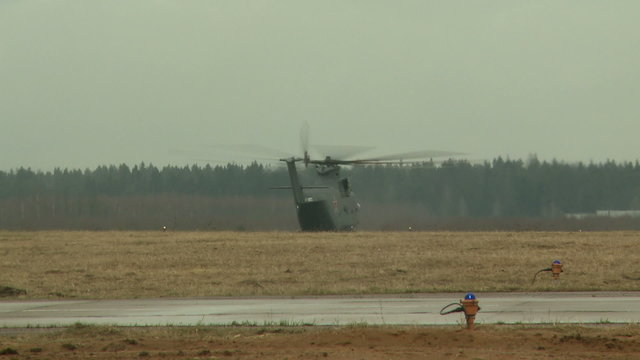 Military helicopter flies through runway