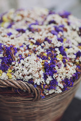 Obraz na płótnie Canvas Violet and white dry flowers in the basket