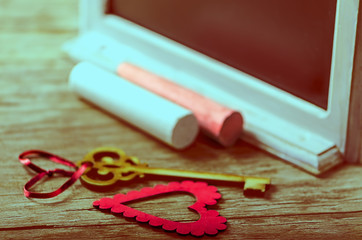 Saint Valentines decoration: heart, key, black board and chalk