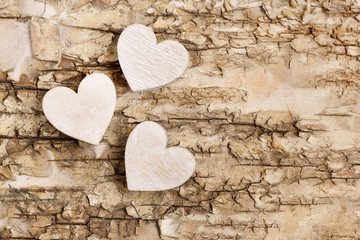Wooden heart on bark background. Symbol of love