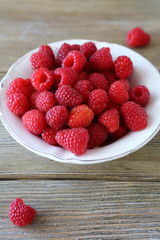 juicy raspberries in a white bowl