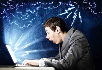 Emotional man using laptop