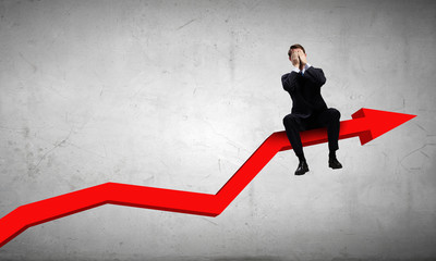 Fototapeta premium Businessman sitting on graph