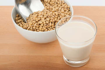 Soy milk in glass with soybeans and  transfer scoop