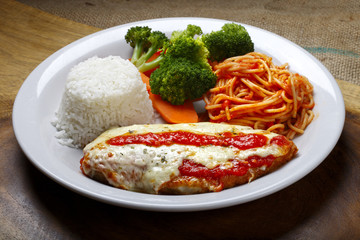 The steak parmigiana with pasta and rice