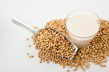 Soy milk in glass with soybeans and  transfer scoop