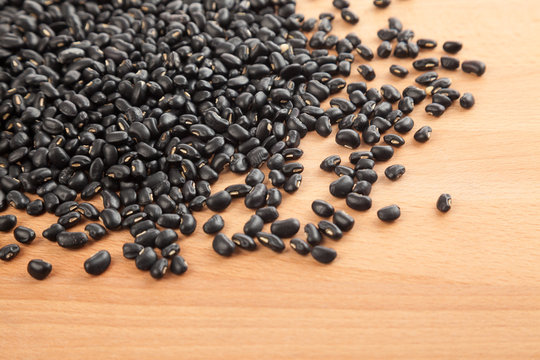 Black beans on wood table © halfbottle
