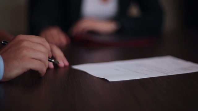 hand of  businessman signing  document or contract