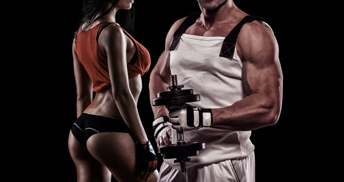 Strong Young Couple Working Out With Dumbbells - Shot In Studio