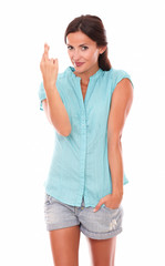 Smiling female with crossing fingers for luck sign