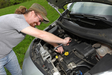 Fototapeta na wymiar mechanic repairs a car on the road
