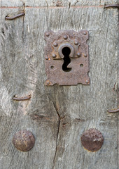 Old run-down wooden door and iron lock