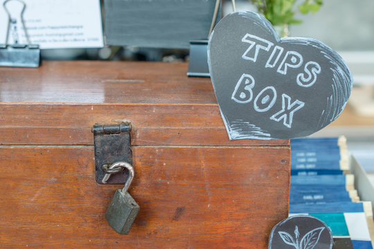 The tips box for good service in restaurant. Tips is a sum of money customarily given by a client or customer to a service worker, in addition to the basic price.