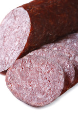 Dry smoked sausage macro isolated on white