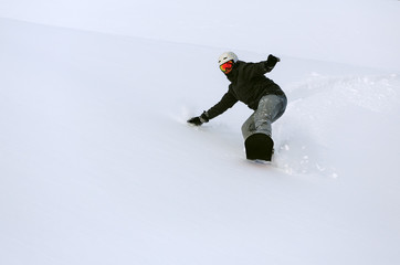 Fototapeta na wymiar Snowboarder doing a toe side carve
