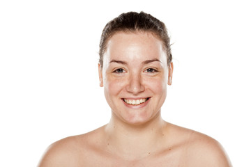 smiling young woman without makeup on white background