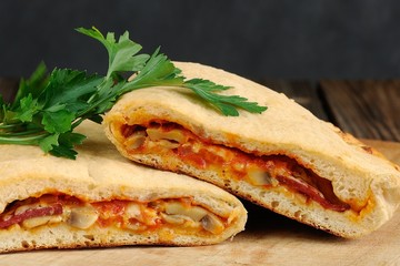 Pizza calzone with mushrooms and fresh parsley