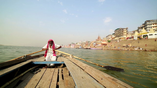 indian boatman at varanasi ganga river