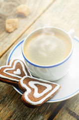 cup of coffee with the chocolate cookies in the shape of a heart