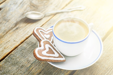 cup of coffee with the chocolate cookies in the shape of a heart