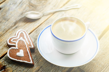 cup of coffee with the chocolate cookies in the shape of a heart