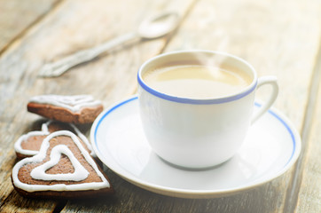 cup of coffee with the chocolate cookies in the shape of a heart